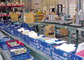 Shipping Station: Workers sort bin-stored product and release to the conveyor system so it can be put away.