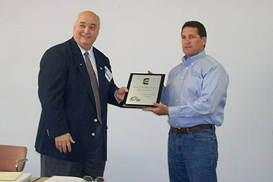 Hytrol's Bill Hawthorne presents a plaque commemorating Cisco-Eagle's conveyor sales achievements to President Steve Strifler