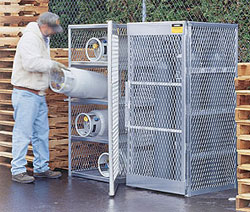 Man loading cylinders into a storage cage