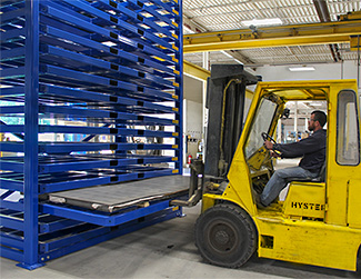 forklift removing sheet metal from stacker