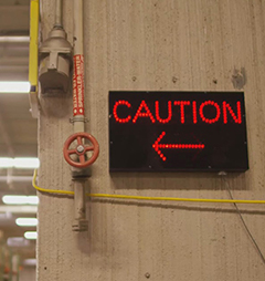 Light-up caution sign in a warehouse