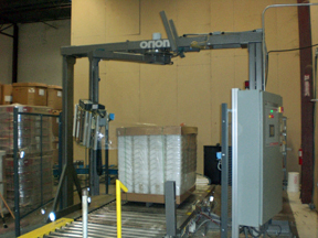 stretch wrapper over a conveyor wrapping a palletized load