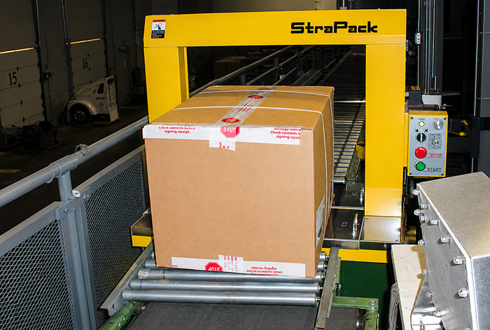 Conveyor integration to automated strapping machine
