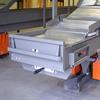 Front end of extendable conveyor with steering arm and safety bumper