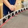 Man using a tool to release belt guides