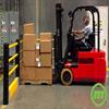 Forklift unloading goods near flexible handrail with crash barrier