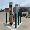 Forest green bollards surrounding an EV charging station