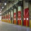 Row of red dock doors with yellow bollards