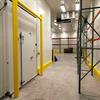 Yellow goal post style guardrail and pallet rack in a warehouse