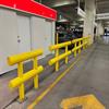 Row of yellow guardrail in a parking garage