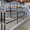Black handrail around pallets with kegs