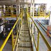 Yellow handrail lining a catwalk in an industrial facility