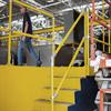 Yellow handrail on yellow steps at platform edge