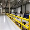 Row of yellow guardrail in a warehouse