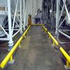 Yellow guardrail lining aisle between hoppers