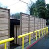 Yellow guardrail in front of wooden structures outdoors