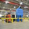 Yellow guardrail surrounding CNC equipment