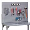Steel pegboard with a variety of tools