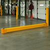 Yellow rail on floor next to yellow bollard near dock door