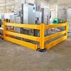 Yellow guardrail surrounding fuse boxes and other equipment in industrial setting