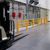 Row of yellow handrail along a wall with electrical boxes, and a forklift in the foreground
