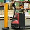 yellow bollard next to walkie pallet truck