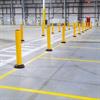 row of yellow bollards in a warehouse