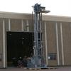 VNA style AGV at full lift height outside a building