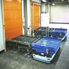 Two AGVs in front of conveyors at overhead doors