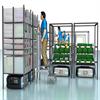 Order pickers working at carts of bins carried by AGVs