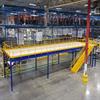 Blue mezzanine with yellow stairs and plywood deck in warehouse