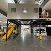 In-plant office on top of mezzanine built over forklift lane in warehouse