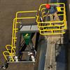 Side view of Cantilever Mobile Work Platform with worker in optional safety cage