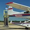 Stability of adjustable height work platform allows worker to move confidently on the workstand