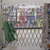 Single gate extended across a retail store aisle.