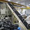 cleated incline conveyor carrying tires