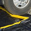 Close-up of wheel as it goes over the soft foam top edge of the Rapid Rise spill containment berm