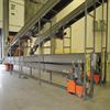 Two overhead sortation conveyors paired with extendable loading conveyors at dock doors