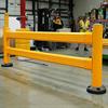 Yellow guardrail near a loading lock with workers and pallet rack