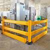 Yellow guardrail surrounding fuse boxes and other equipment in industrial setting