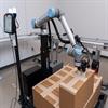 Cobot placing box in precise location on pallet
