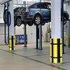 Square parking column protectors used in an auto repair shop. They have used yellow corners and black planks