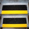 Black step covers with safety yellow nosing used on diamond plate stairs