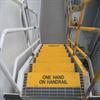 Yellow step covers include safety message "One hand on handrail"