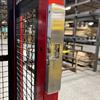 Electric strike mounted on door frame of wire cage in warehouse