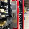 Electric strike mounted on door frame of wire cage with service window in warehouse