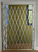 Folding gate across an indoor doorway