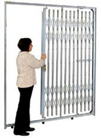 Woman operating a folding storefront gate