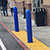 Blue bollards in front of a store with sliding glass doors