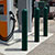 Forest green bollards surrounding an EV charging station
